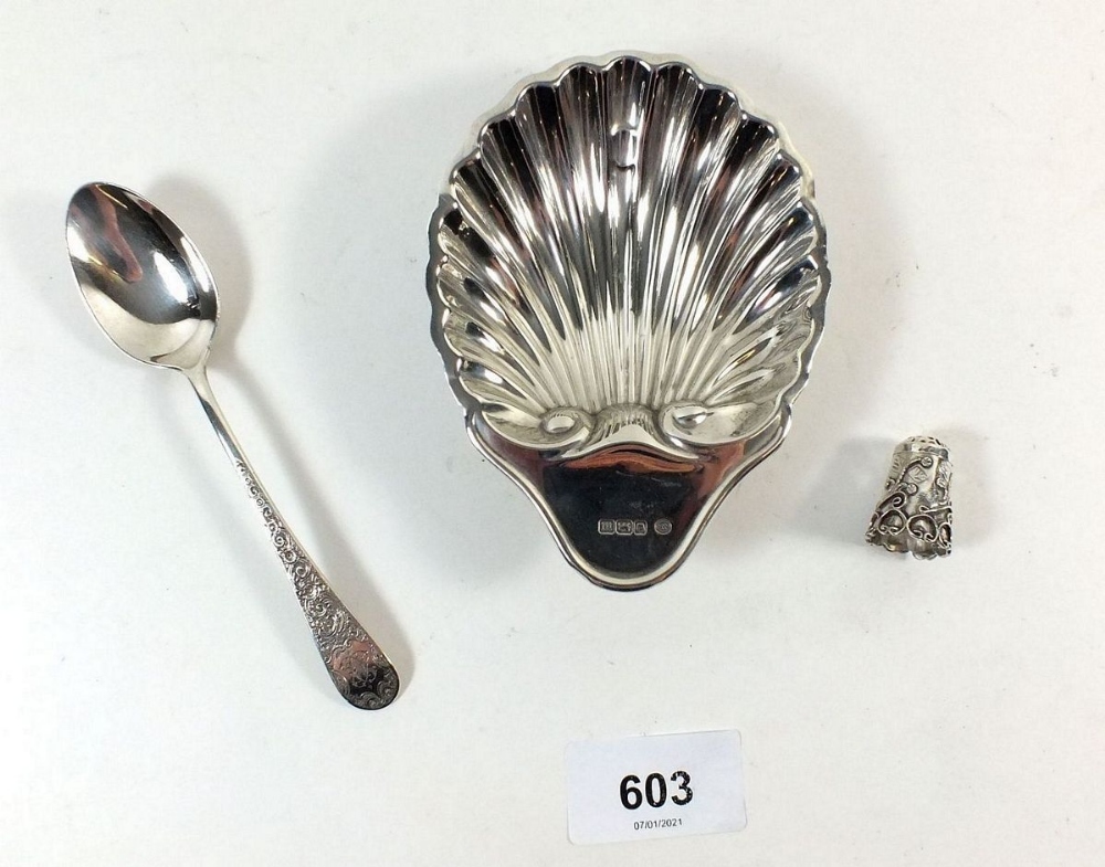 A silver shell form dish, Victorian silver teaspoon with embossed design and a decorative silver