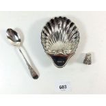 A silver shell form dish, Victorian silver teaspoon with embossed design and a decorative silver