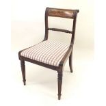 A 20th century Regency style chair with brass inlay