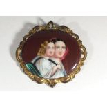 An oval porcelain brooch painted two women in gilt metal frame, 7cm x 7cm