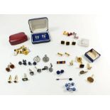 A box of various cufflinks