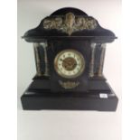 A Victorian large black slate mantel clock with gilt metal mask and architectural decoration