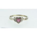 A 9ct gold ring with amethyst heart form stone within chip diamond surround, Size L -1.5g