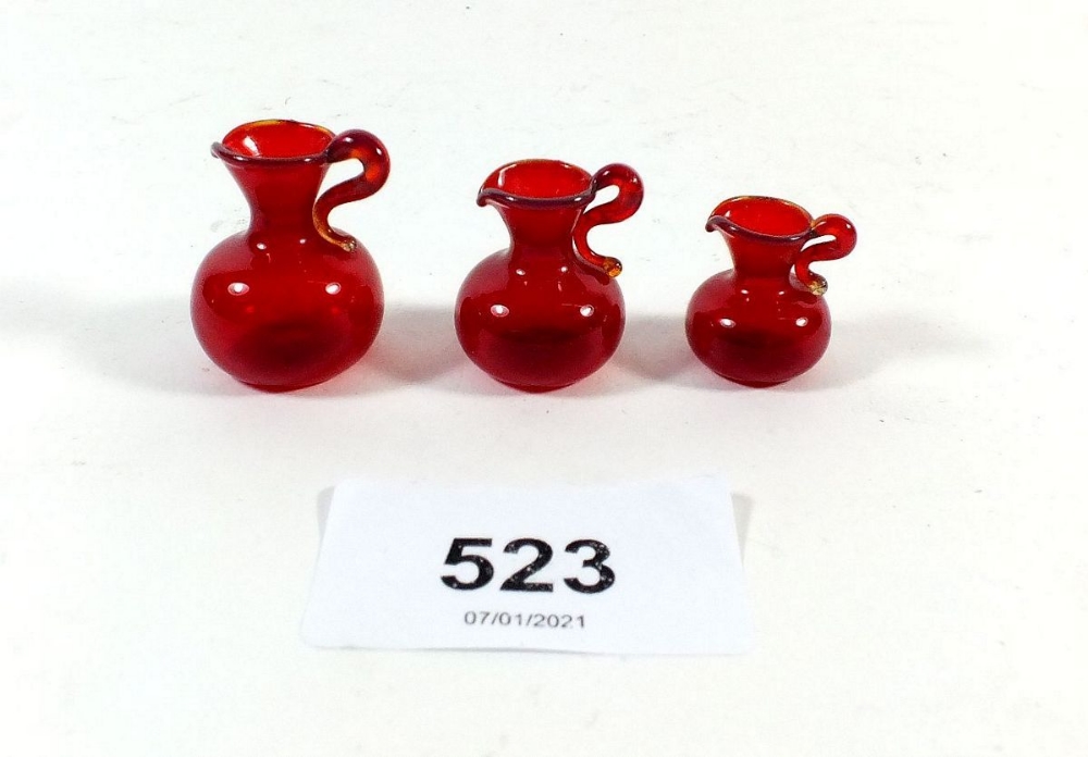 Three miniature dolls house red glass vases