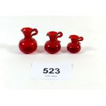 Three miniature dolls house red glass vases