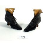 Two black porcelain shoes, 11.5cm long