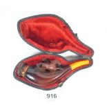 A Meerschaum pipe carved in the form of two horses and an amber mouthpiece, cased