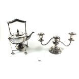 A silver plated tea kettle and a silver plated candelabra