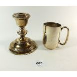 A silver christening mug Birmingham 1915, 98g and a silver candlestick Birmingham 1959