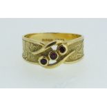 An 18ct gold ring crossover set three rubies on wide band - size M-N, 5g