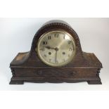 A 1920's oak chiming mantel clock with key, a/f
