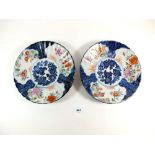 A pair of 19th C Japanese Imari fluted dishes with floral decoration, impressed maker's mark to