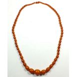 A golden amber bead necklace, 47g