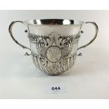 A large Queen Anne silver porringer or caudle cup, London 1706 by John Abbott, with embossed