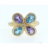 A 14ct gold ring set blue topaz and amethyst - size M-N