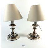 A pair of small Sheffield plated candlesticks converted to table lamps, with shades