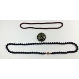 A long blue glass bead necklace100cm, a garnet bead necklace and vintage green large brooch