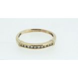A gold ring set line of small diamonds, size M - 1.4g, not marked but tested as gold
