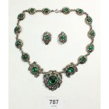 A vintage green stone and white metal necklace and earrings