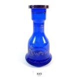 A blue moulded glass decanter with gilt desert scene decoration