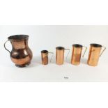 A set of four copper measures, largest 10cm plus copper tankard