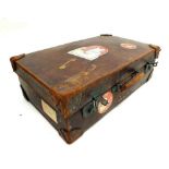 An early 20th century leather suitcase with Cunard Line labels