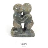 A small tribal hardstone carved figure of two boys, possibly African or Inuit in origin, 11cm