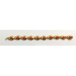 An 18ct gold oval link bracelet set coral, 17g