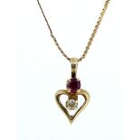 A 10ct gold diamond and ruby set heart form pendant on fine chain
