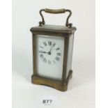 A brass carriage clock with key, 11cm tall