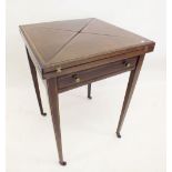 An Edwardian envelope card table with baize interior and counter dishes, 51 x 51 x 78cm .