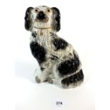 A 19thC Staffordshire black and white spaniel figure, 24cm.