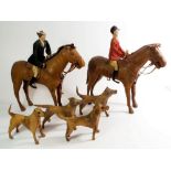 An early 20th century leather clad model toy hunting set comprising two horses, two riders and