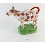 A Staffordshire pink lustre cow creamer, detached from base, horns restored
