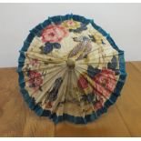 A Japanese style parasol with bamboo effect handle and floral printed fabric shade