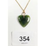 A jade heart shaped pendant on 9 carat gold chain, pendant size 2.1cm wide