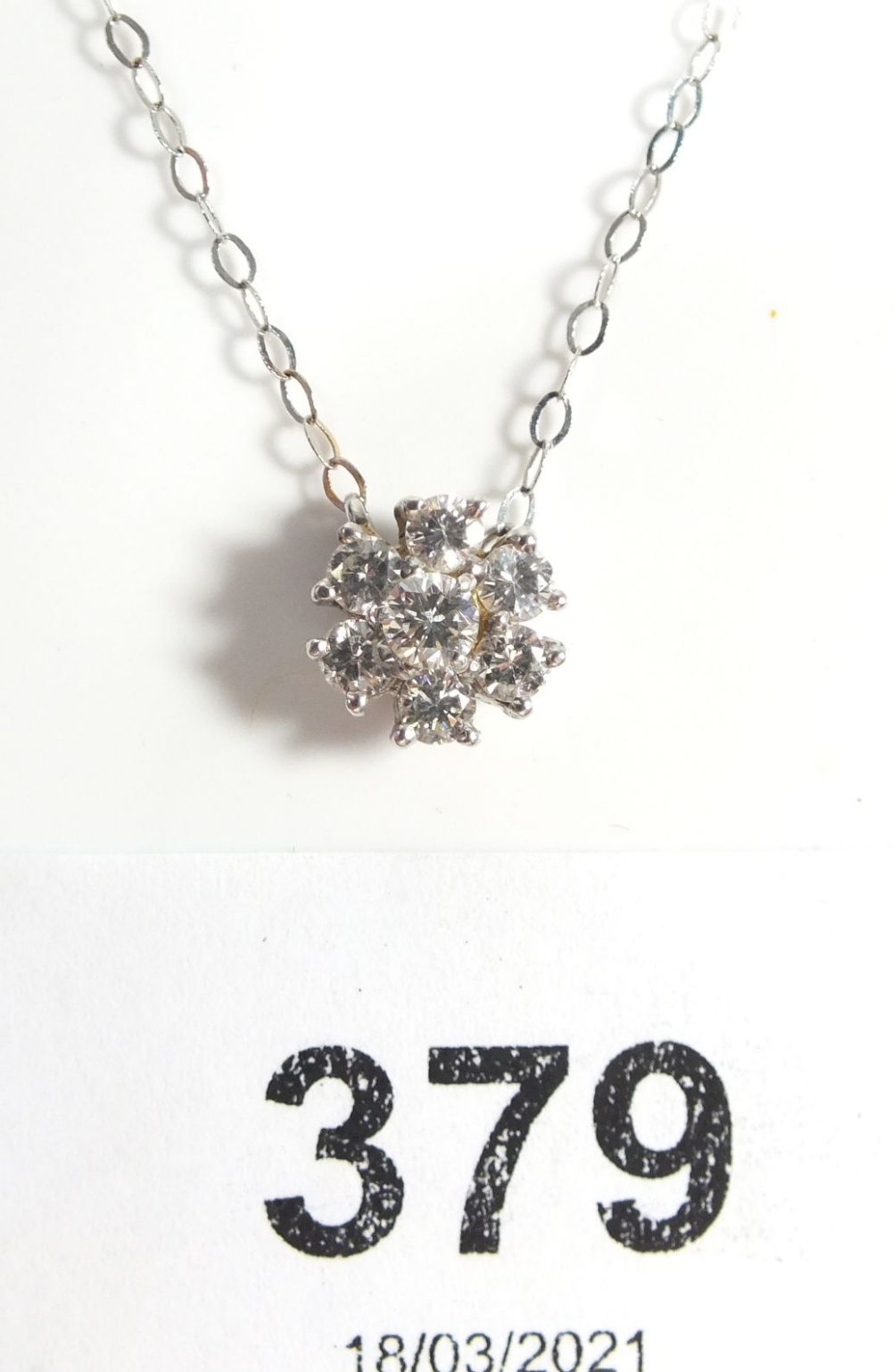 An 18ct white gold diamond cluster pendant on fine 18ct white gold chain