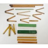 A selection of folding boxwood rulers and some straight rules