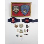 A small selection of military, police and St Johns ambulance badges and insignia