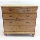 An Edwardian pine chest of two short and three long drawers, 102cm wide x 49cm deep x 102cm tall