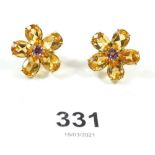 A pair of 18ct gold flower form earrings, set citrines and pink sapphires (clips for pierced ears)