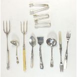 A group of silver plated antique serving cutlery including toasting forks, sifter spoons, pickle