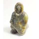 A Greenland Inuit carved stone kneeling figure, signed 'Lauge FM Nuuk', 8cm