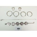 Three pairs of silver hoop earrings and two silver bracelets