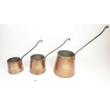 Three graduated copper cider measures