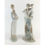 A Lladro figure of boy with kid goat and a girl with kid goat