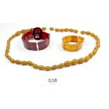 An amber necklace and two simulated amber bracelets