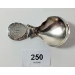 A silver caddy spoon with disc form handle, Birmingham 1822, by Joseph Willmore