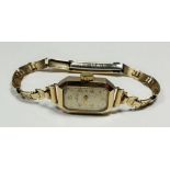 An Edwardian 9 carat gold ladies wrist watch with rolled gold strap