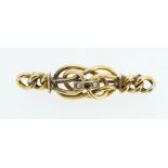 A 9ct gold knotted bar brooch set garnet and seed pearls, 2.8g